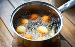 In a saucepan over medium heat (or even slightly lower than medium heat), heat vegetable oil for deep frying and put balls of cottage che...