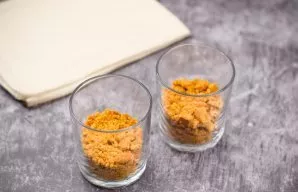 Prepare glasses. Put cookie crumbs in glasses as the first layer - the third part of the cup.