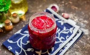 Lay out the salad in sterile jars and immediately roll up. Put it upside down, wrap it. After a day, put in the pantry.