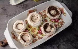 Transfer the cleaned mushroom caps to a suitable baking dish.