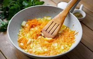 Heat vegetable oil in a pan and add chopped carrots and onions. Cook over low heat until the vegetables are tender.