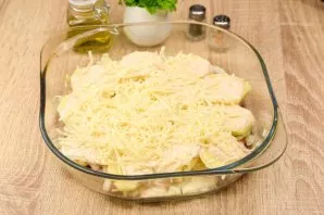 Then grate the hard cheese and put half the cheese in a mold.