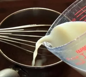 Add the remaining milk and cold water there. Beat with a whisk.