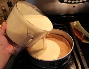 Pour the curd mixture evenly into the mold.