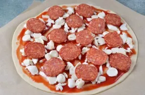 Spread pepperoni slices on top. Put in the oven, heated to 200 degrees, for 15 minutes in the lower and upper heating mode.