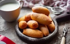 Cool the prepared donuts slightly, if desired, sprinkle with powdered sugar and serve.