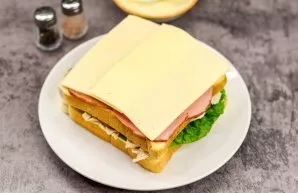 Put slices of cheese on top of the tomatoes.