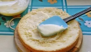 Sprinkle the cakes with syrup. Grease one cake with cream, cover it with the second cake on top. Also apply cream to the top and sides of...