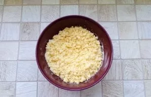 With a spoon, fork, or hand, mix the dry ingredients with butter until crumbs are formed.