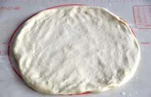 Prepared dough patty by hand.