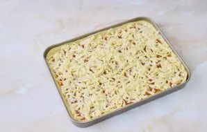 Grate the frozen dough over the entire surface of the cake. Place in the oven and bake at a temperature of 180 degrees for about 25-30 mi...