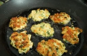 And bake pancakes on both sides until golden brown. Put chicken pancakes with cheese and herbs on a paper towel, and then serve with sour...