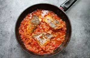 Carefully turn the fish over and simmer for another 10 minutes. Then remove from heat and serve.