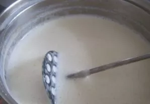 And pour milk into the resulting mass in small portions. Stir so that there are no lumps. And put on medium heat. Bring to a boil, stirri...