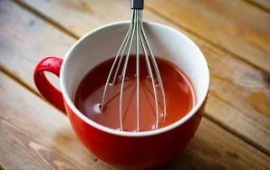 In a separate bowl, beat the water and tomato sauce until smooth.