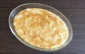 With the remaining dough, fill the apple layer. Sprinkle the dough with brown sugar. Place the container with the dough in an oven prehea...