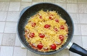 Sprinkle pizza with grated cheese.