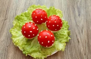 Decorate the tops of the caps with dots of mayonnaise, turning them into flies.