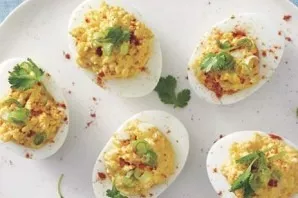 Decorate the finished eggs in the Mexican style with herbs and serve. Delicious!