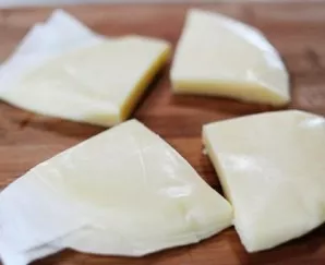 Cut the cheese into equal pieces.