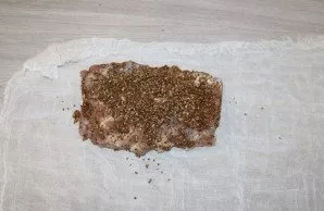 Take a large piece of cheesecloth and place the meat on it.