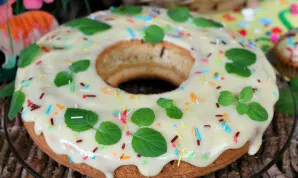 Cool the cake and grease with cream. Before serving, you can decorate with colored sprinkles and mint leaves.
