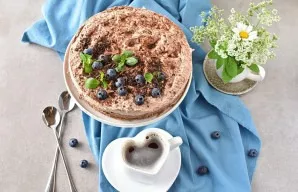 Serve cheesecake immediately, well chilled. Before serving, sprinkle the cheesecake with the remaining cocoa powder and garnish with choc...