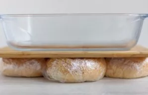 Place the buns in a pile, place a cutting board on top of the buns and a bowl of water on top to press the buns. and refrigerate for 1 ho...