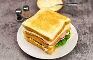 Put the third toast on top of the cheese.