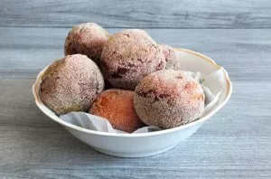 Transfer the donuts to a plate lined with paper towels. Cool slightly and serve.