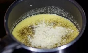 Then add half the finely grated cheese. Cook the sauce until the cheese is completely melted.